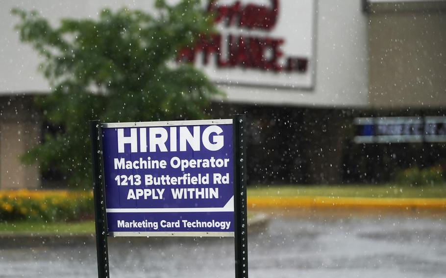 A hiring sign is displayed in Downers Grove, Ill., on June 24, 2021.  
