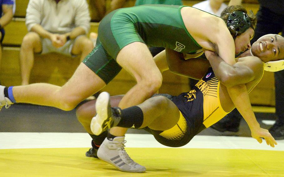 Kubasaki's Max Lundberg gains the early edge on Kadena's James Kinney during Wednesday's Okinawa wrestling dual meet. Kinney rallied for a pin in 1 minute, 5 seconds and Kadena won the meet 42-15.