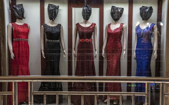 Mannequin's heads are covered in a women's dress store store in Kabul, Afghanistan, Monday, Dec. 26, 2022. Under the Taliban, the mannequins in women's dress shops across the Afghan capital Kabul are a haunting sight, their heads cloaked in cloth sacks or wrapped in black plastic bags. 