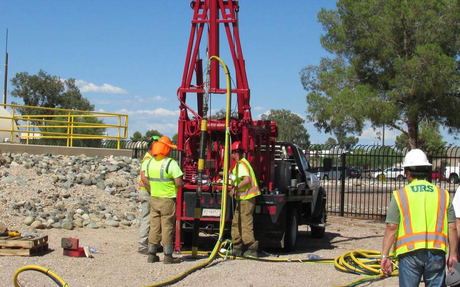An environmental restoration crew lowers an injection tool into a well as part of the environmental hydrofracturing process. The technology creates small underground cracks into which a slurry of sand, soy beans, laundry detergent, nutrients and micro-organisms will be injected to accelerate removal of contamination previously trapped in dense soils around Air Force Plant 44 in Tucson, Arizona.