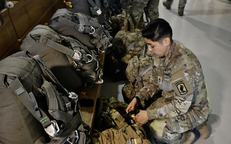 Sgt. 1st. Class Alina Zamora prepares her rucksack before taking part in the 173rd Airborne Brigade's all-female parachute jump near Vajont, Italy, on March 14, 2024.