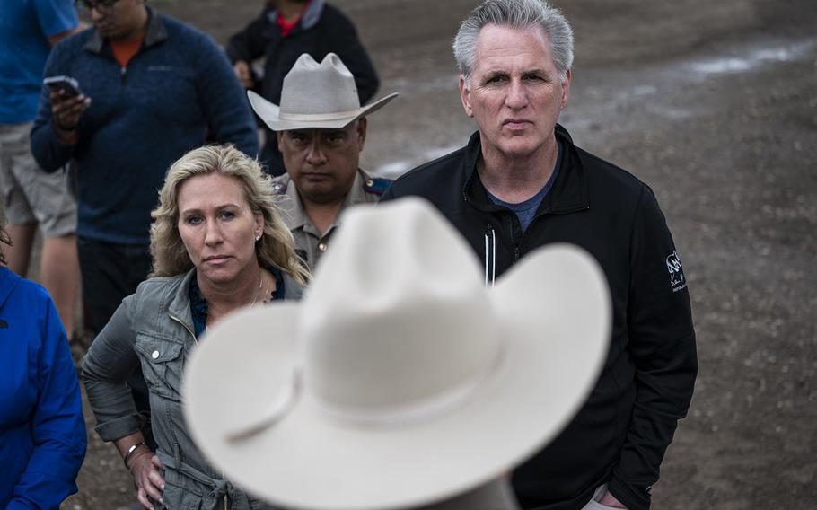 Rep. Marjorie Taylor Greene, R-Ga., and House Minority Leader Kevin McCarthy, R-Calif., receive a briefing under the Eagle Pass International Bridge from Texas to Mexico during a tour of the border on April 25, 2022.