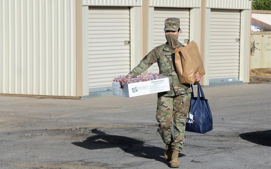 Estrella Cardenas brings cookies to the Holloman ARB Cookie drive drop-off at the Alamogordo Center for Commerce on Dec. 6, 2021. The Holloman AFB Airmen Cookie Drive provides cookies to Airmen staying in the base dorms through the holidays.