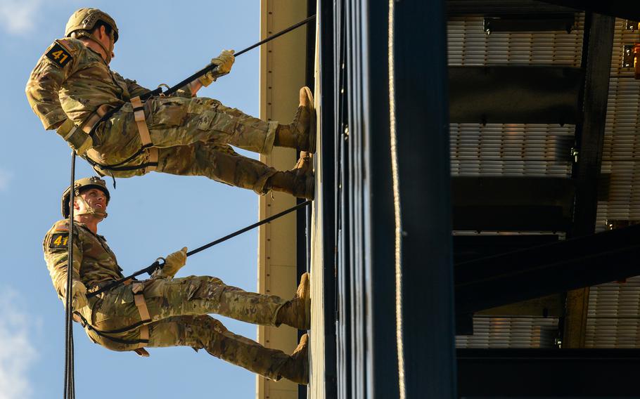 Army 1st Lt. Patrick Sutherland and 1st Lt. Colin Johnson of the 75th Ranger Regiment rappel down a wall during the final day of the Army’s annual Best Ranger Competition on Sunday, April 14, 2024, at Fort Moore, Ga. 