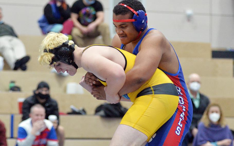 Ramstein’s Lebron Thomas, right, has his grip on Stuttgart’s Hayden Kniss, on his way to taking the 285-pound title at the high school 2022 Wrestling Tournament in Ramstein, Germany, Feb. 12, 2022.