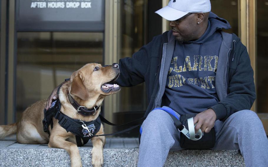 Garland Shirley with his service dog, Smitty.