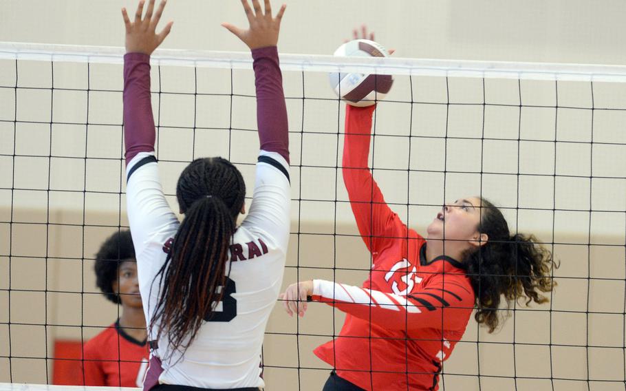E.J. King's Mackinzi Dudley tries to hit the ball past Matthew C. Perry's Aisha Watley during Saturday's DODEA-Japan volleyball match. The Cobras won 25-10, 25-15, 25-13, hours after also beating the Samurai 25-7, 25-10, 25-7 on Friday.