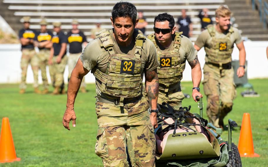 Best Ranger Competition competitors Sgt. Maj. Eric Echavarria and Master Sgt. Charles Gonzalez from the U.S. Army Special Operations Command evacuate a casualty dummy during the second day of the competition, Saturday, April 15, 2023, at A.J. McClung Memorial Stadium in Columbus, Ga