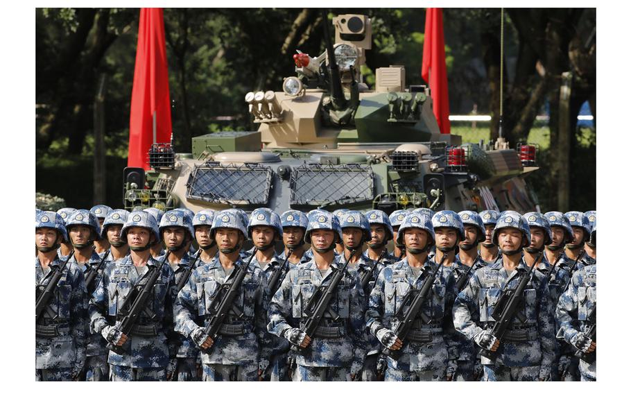 People's Liberation Army troops stand in formation during a ceremony at the Shek Kong Barracks in Hong Kong on June 30, 2017.