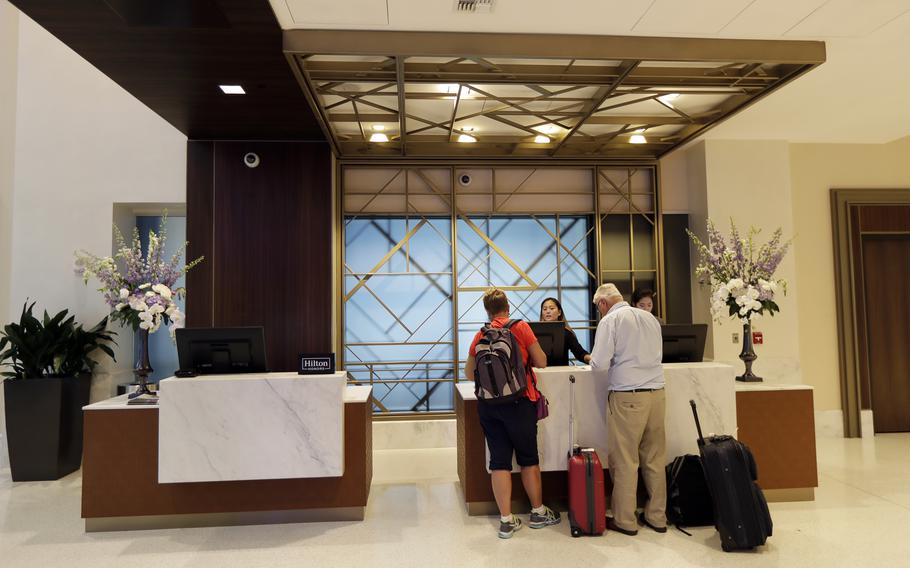  In this Sept. 5, 2018, file photo guests stand at the front desk at the Embassy Suites by Hilton hotel in Seattle’s Pioneer Square neighborhood in Seattle. In the 1990s and early 2000s, hotels began offering 100% Satisfaction Guarantees to customers. The promise ensured that customers who were dissatisfied with their service would be guaranteed full refunds with no questions asked. Fast forward to 2022, and it looks like this prevailing expectation has had a negative impact on the overall hotel experience for customers. 