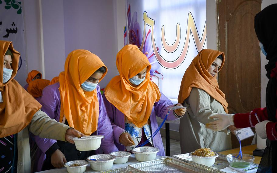 Women working for Rumi Spice, a saffron import company founded in 2014 by U.S. military veterans, bring forward saffron they have processed for inspection. Saffron companies often employ women to process the spice, known as the most expensive in the world.