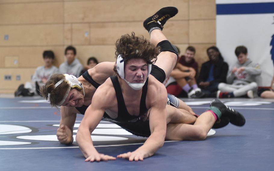 Hohenfels' Joel Workman, back, slams Vilseck's Garrett Hyten to the mat during the 175-pound championship bout at the DODEA Central Europe wrestling sectional on Saturday at Ramstein High School on Ramstein Air Base, Germany. Hyten won the match, 9-1.