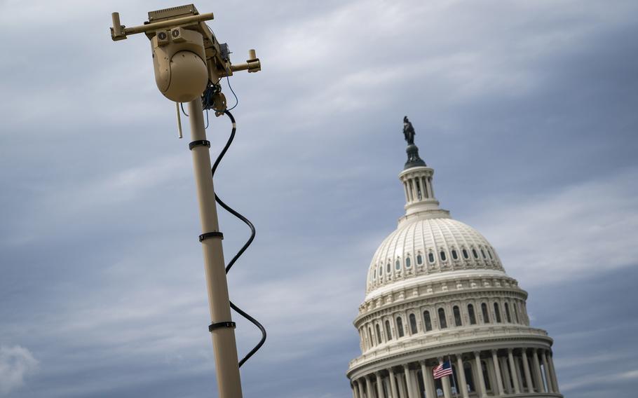 Workers set up surveillance equipment outside the U.S. Capitol in 2021. 