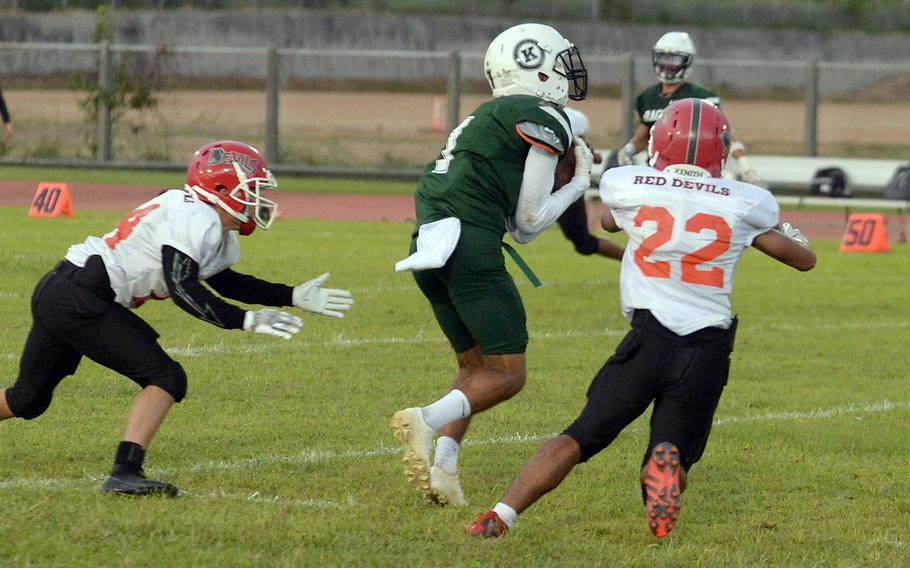 Kubasaki's Justin Murray snags a pass between Nile C. Kinnick defenders Kain Mauldin and Kenji Buckner.