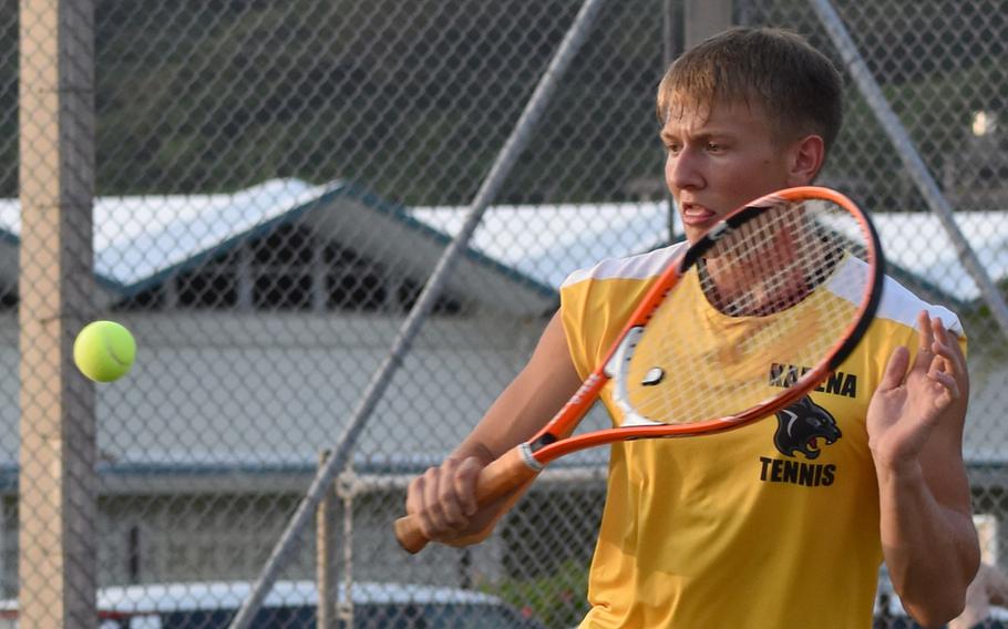Iain Stanley hits a backhand return during Thursday's Okinawa tennis matches. Stanley teamed with Destiny Richardson in an 8-5 mixed-doubles loss to Josh Wall and Isabella Suber of Kubasaki.