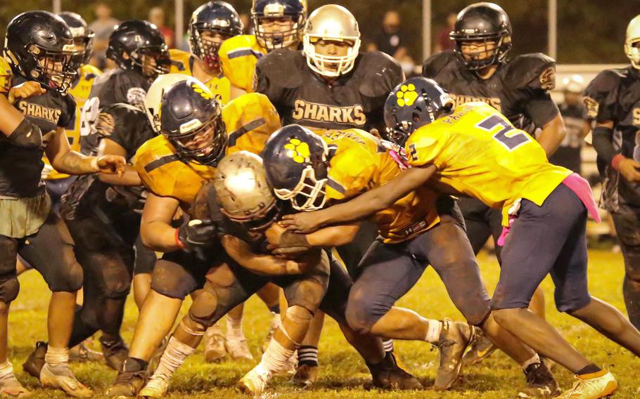 Guam High's defense faced its share of oppositioin, the rain, mud and Simon Sanchez's wishbone offense, but the Panthers found a way to win 44-32.