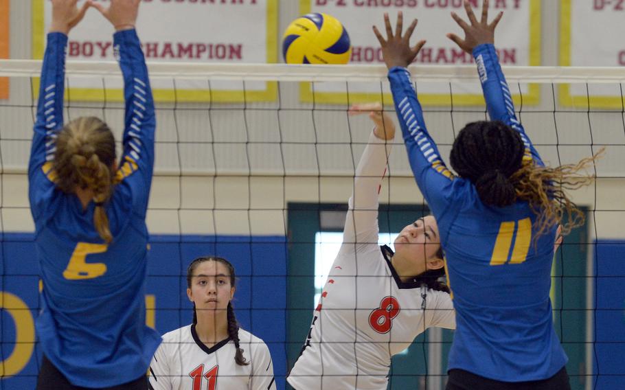 E.J. King's Sarah Goleman spikes between Yokota's Annie Mitchell and Brianna Moore during Saturday's DODEA-Japan volleyball match. Goleman celebrated her 16th birthday Saturday as the Cobras won in straight sets, sweeping the two weekend matches vs. the Panthers.