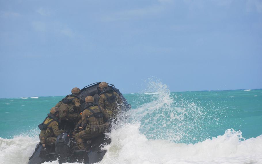 Soldiers with the Australian Army’s 2nd Battalion, Royal Australian Regiment crash through a wave aboard an inflatable dinghy as they head away from Bellows Air Force Base, Hawaii, July 18, 2022, during helocasting training.