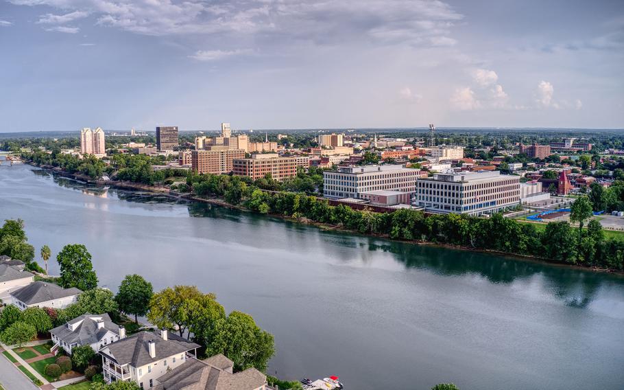 The skyline of downtown Augusta reflects in the Savannah River, the dividing line with North Augusta, S.C.  