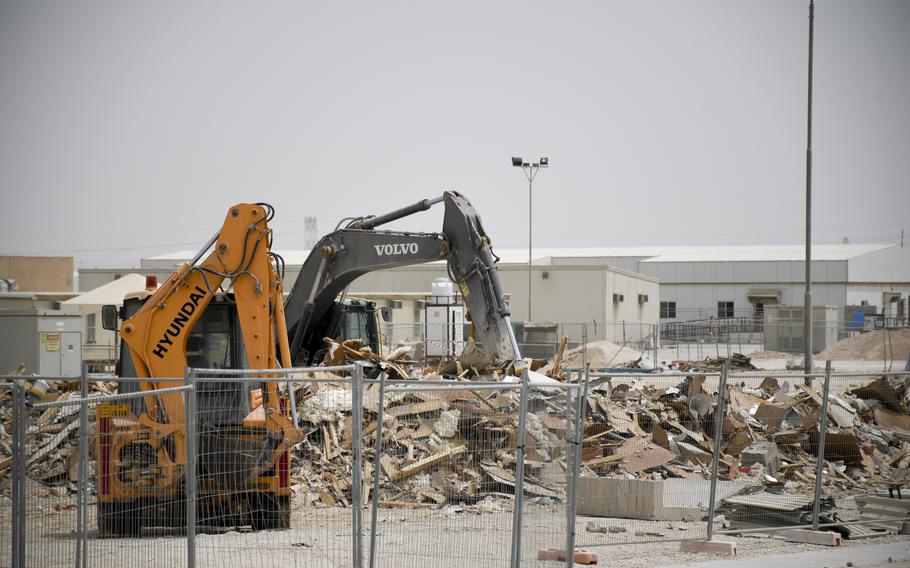 Heavy machinery demolishes temporary housing at Al Udeid Air Base, Qatar, on April 22, 2022, as part of an expansion project at the base.