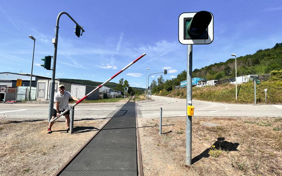 Riding a draisine on the Glan Valley line requires crossing a few active roadways. Passengers simply wait for the crossing light before opening the gate arm and carefully crossing the road.