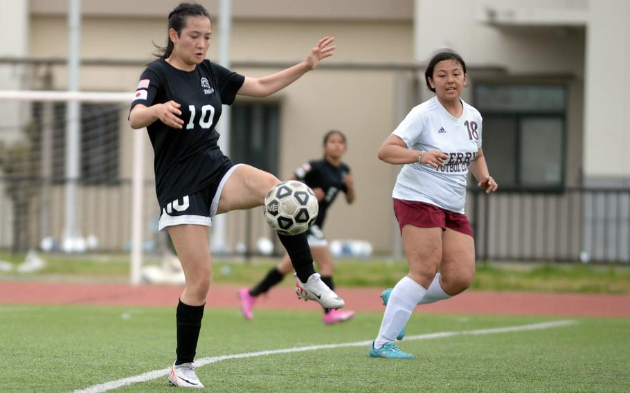 Zama‘s Sara Zambrano steadies the ball in front of Matthew C. Perry’s Markeean Lutz during Saturday’s DODEA-Japan girls soccer match. The Samurai won 4-1.