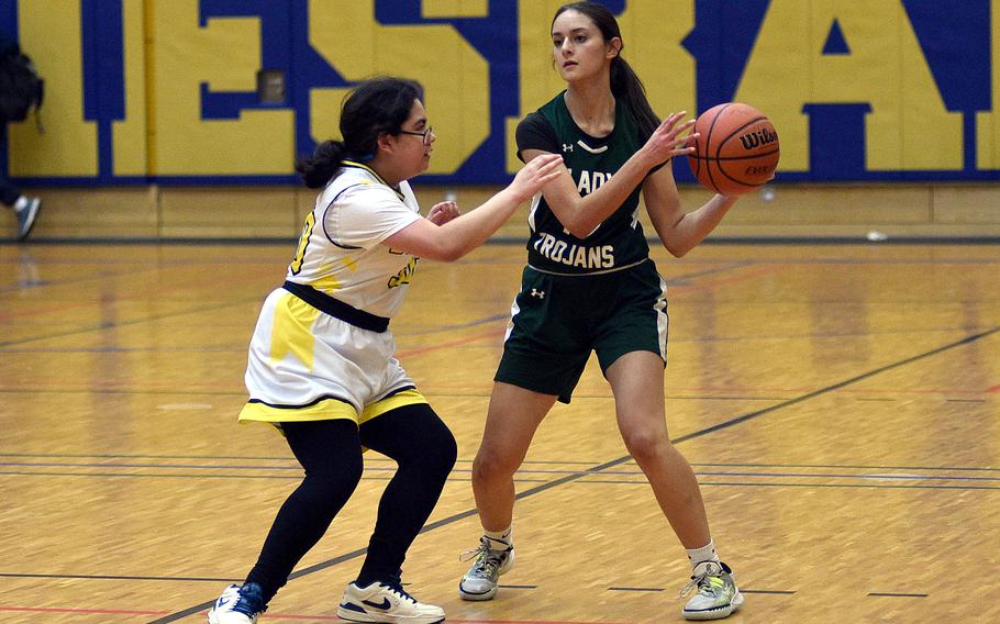 Ankara senior Jaia Kageorge looks to pass while Alconbury sophomore Isabella Free defends in pool-play action of the DODEA European Basketball Championships on Feb. 15, 2024, at Wiesbaden High School in Wiesbaden, Germany.