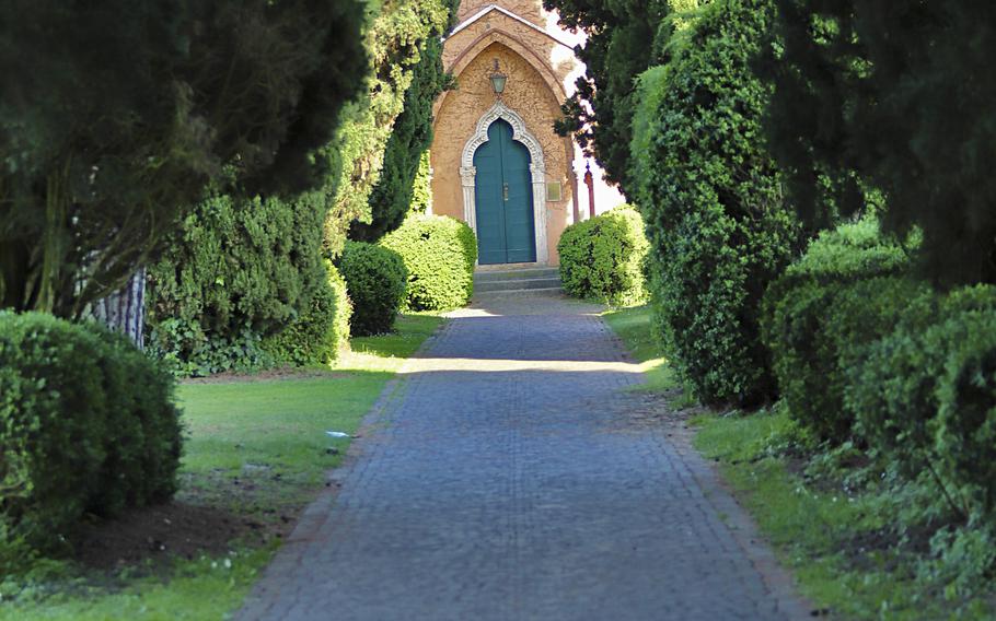 The Castelletto, a castle-shaped building, as seen from the Sunset Avenue walkway inside the Garden Park Sigurta near Verona, Italy. The park has an immense number of plants, trees and flowering gardens.