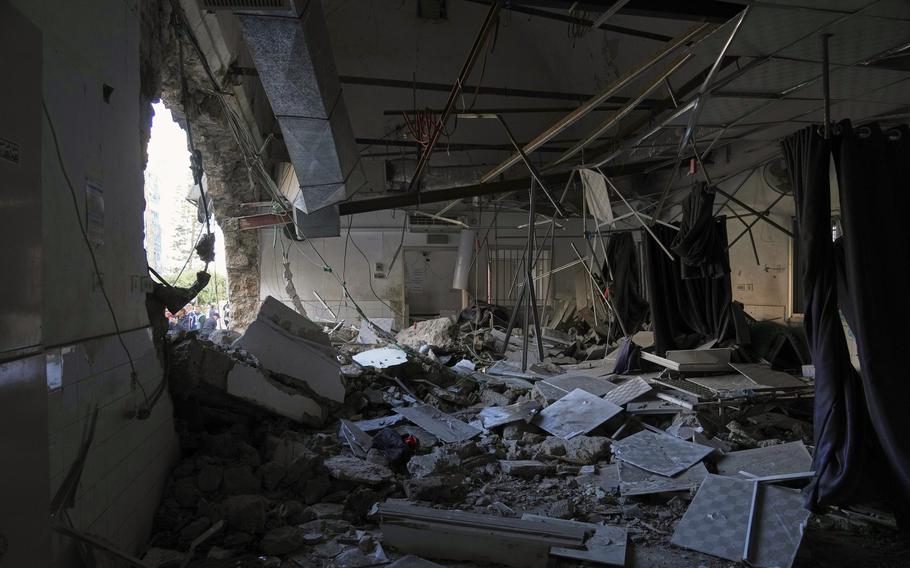 The aftermath of an airstrike shows gaping holes in walls, a ceiling coming apart and debris scattered across a room.