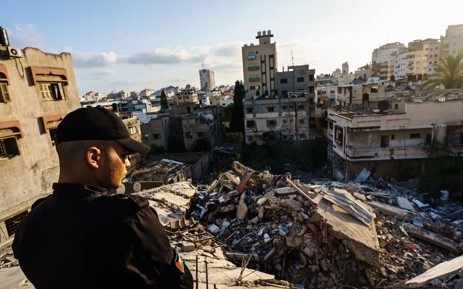 Police officers inspect the ruins of Samir Mansour's bookstore and nearby buildings, which were destroyed by Israeli bombardment during the last escalation between Israel and Gaza military factions, in Gaza City on Saturday, May 29, 2021.