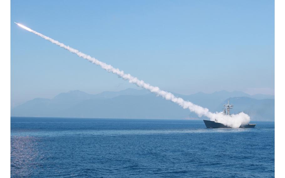 A Taiwanese guided-missile frigate fires a missile on Tuesday during exercises outside Suao, Taiwan. 