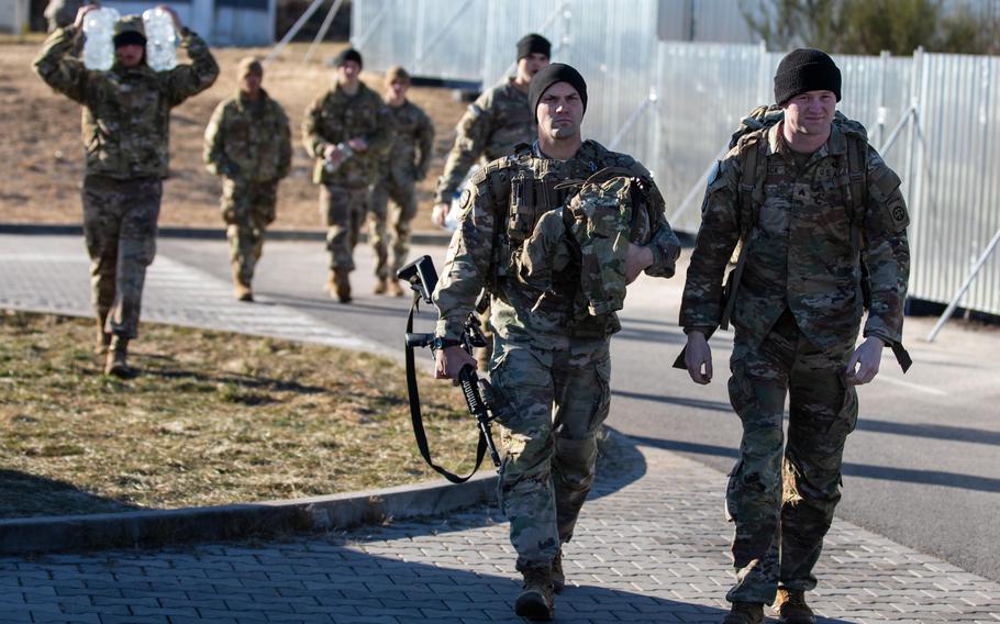 Paratroopers assigned to the 82nd Airborne Division carry their equipment and supplies to their vehicles before departing the G2A Arena in Rzeszow, Poland, Feb. 12, 2022. U.S. Defense Secretary Lloyd Austin is headed to Brussels, Belgium, to discuss Russias military buildup near Ukraine with NATO defense ministers on Wednesday and Thursday.
