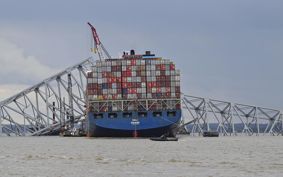 Workers dismantle the collapsed Francis Scott Key Bridge in Baltimore on Thursday.