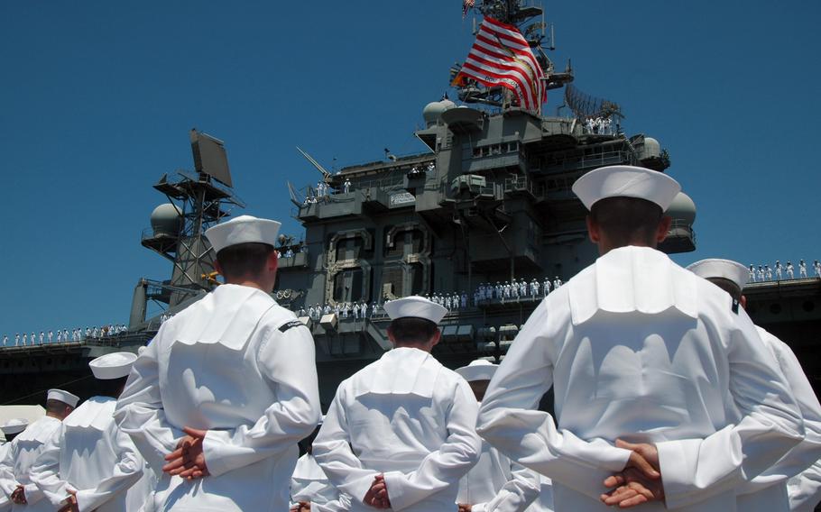 Sailors at Naval Air Station North Island stand at parade rest to welcome the aircraft carrier USS Kitty Hawk as she returned to her homeport of San Diego in 2008. The carrier was the oldest active-duty warship in the Navy until it was replaced by the nuclear-powered aircraft carrier USS George Washington.