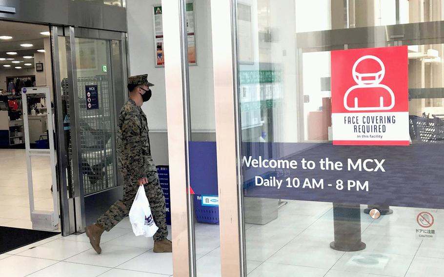 A Marine leaves the exchange at Marine Corps Air Station Iwakuni, Japan, where all patrons are required to wear a mask, Wednesday, Jan. 5, 2022. 