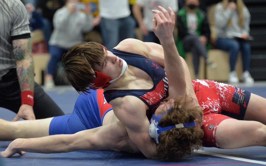 Lakenheath’s Gavin Idleman puts the pressure on Ramstein’s Matthew Abel, on his way to taking the 157-pound title at the high school 2022 Wrestling Tournament in Ramstein, Germany, Feb. 12, 2022.