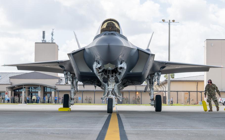 An F-35A fighter jet is seen from the front/nose on a runway.