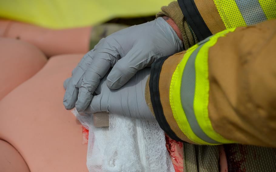 An 86th Civil Engineer Group firefighter provides pressure to an abdominal wound on a medical training mannequin during a simulated aircraft crash scenario at Ramstein Air Base, Germany, July 26, 2022.