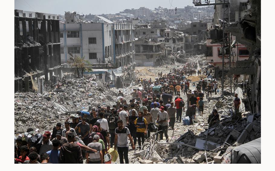 Palestinians make their way as they inspect the damages after Israeli forces withdrew from a part of Jabalia refugee camp, following a raid, in the northern Gaza Strip, May 30, 2024.