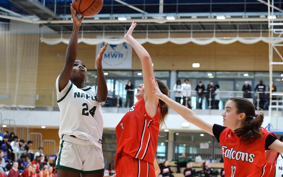 Naples’ VaNae Filer shoots over AOSR’s Nina Neroni and Caitlin Duggan in the girls Division II final at the DODEA-Europe basketball championships in Wiesbaden, Germany, Feb. 17, 2024. Naples won 48-29.