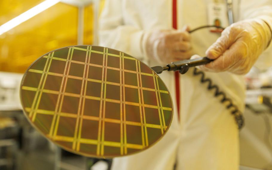 Technicians inspect a semiconductor wafer during testing in the cleanroom at the Tower Semiconductor Ltd. plant in Migdal HaEmek, Israel, on Feb. 28, 2022. 