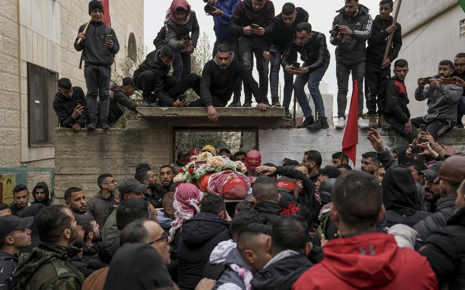 Mourners carry the body of 14-year-old Palestinian Omar Khumour during his funeral in the West Bank city of Bethlehem, Monday, Jan. 16, 2023. The Palestinian Health Ministry said Khumour died after being struck in the head by a bullet during an Israeli military raid into Dheisha refugee camp near the city of Bethlehem.