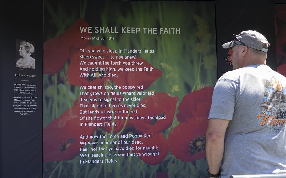 A visitor looks at a panel at the USAA Poppy Wall of Honor on Saturday, May 28, 2022, in Washington, D.C.