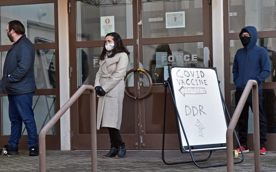 High-priority beneficiaries wait in line at Ramstein Air Base, Germany, in January 2021, to receive the Moderna COVID-19 vaccine. A newly released Pentagon Inspector General report said vaccine rollouts overseas were hampered by insufficient data, among other problems.