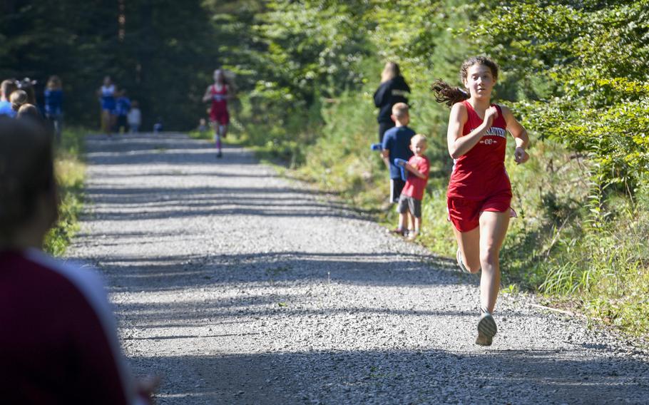 Piper Parsells, 16, a junior at Kaiserslautern, races to the finish line at a high school girls’ varsity cross country meet Saturday, Sept. 18, 2021, in Kaiserslautern, Germany.