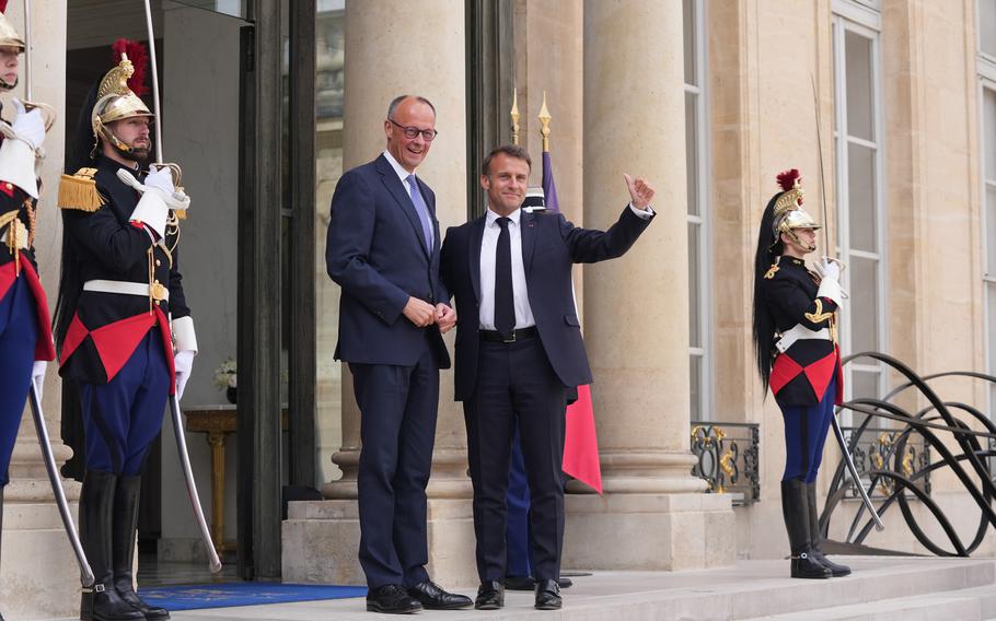 Emmanuel Macron, right, welcomes Friedrich Merz in Paris on May 7. 