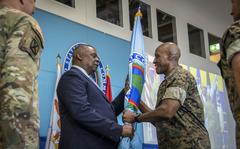 Defense Secretary Lloyd Austin hands the U.S. Africa Command guidon to Gen. Michael Langley during a change of command ceremony in Stuttgart, Germany, Aug. 9, 2022. 