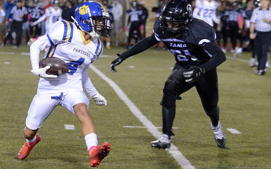 Yokota's Royce Canta looks for running room against Zama's Caleb Schmiedel.