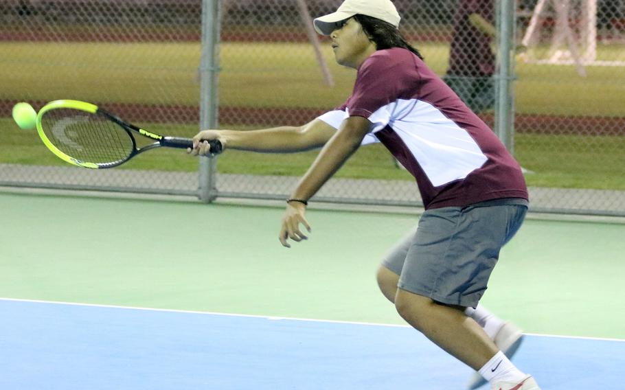 Matthew C. Perry's Gavin DeGuzman lunges to hit a forehand return against Nile C. Kinnick's Alex Cato during Friday's tennis matches. DeGuzman won 9-8 (7-4) in a tiebreak.