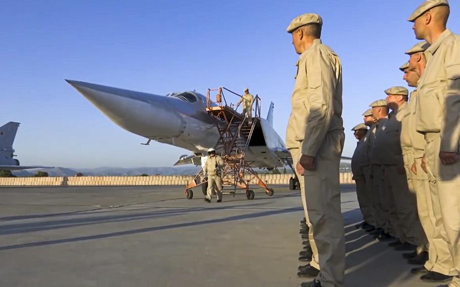 In this photo taken from a video provided on Tuesday, May 25, 2021, by the Russian Defense Ministry Press Service, crew members leave a Russian Tu-22M3 bomber upon its landing at Hemeimeem air base in Syria.